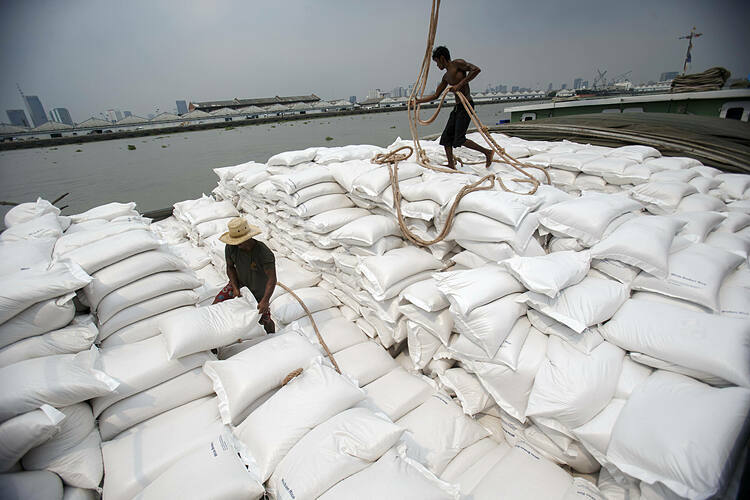 Công nhân chuyển gạo bên bờ sông Chao Phraya (Thái Lan). Ảnh: Reuters
